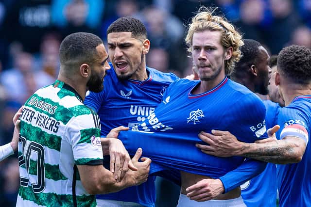 Celtic's Cameron Carter-Vickers grabs Rangers' Todd Cantwell by the shirt at full time.