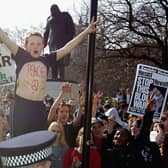 A young protester with 'peace' written on his chest demonstrates outside the Houses of Parliament with military action against Iraq loomng in 2003