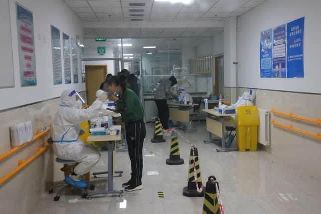 People wait in line for a swab test at a Covid-19 test in Beijing. Picture: Lintao Zhang/Getty Images