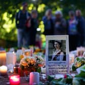 Floral tributes and candles from members of the public are laid in Green Park near to Buckingham Palace