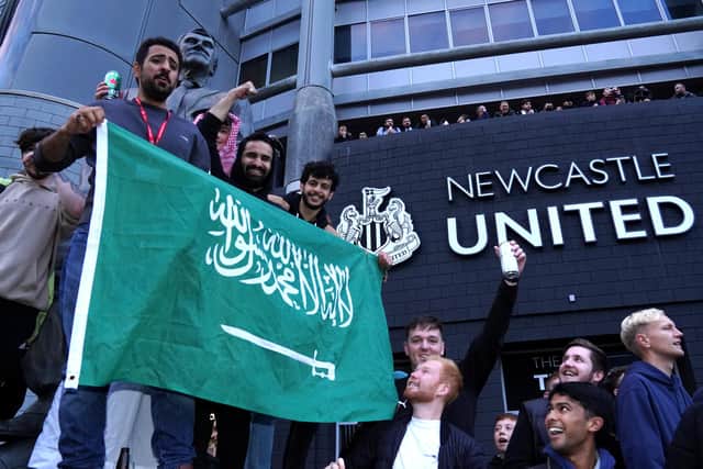 Newcastle United fans celebrate at St James' Park following the announcement that The Saudi-led takeover of Newcastle has been approved.