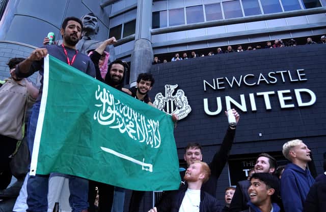 Newcastle United fans celebrate at St James' Park following the announcement that The Saudi-led takeover of Newcastle has been approved.