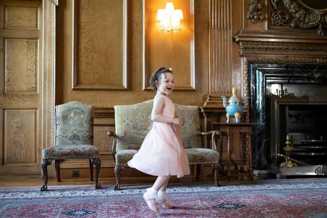 Five year-old Mila Sneddon, a cancer patient who featured in an image from the Hold Still photography project which showed her kissing her father Scott through a window whilst she was shielding during her chemotherapy treatment, waits to meet Britain's Catherine, Duchess of Cambridge at the Palace of Holyroodhouse in Edinburgh, Scotland on May 27, 2021.