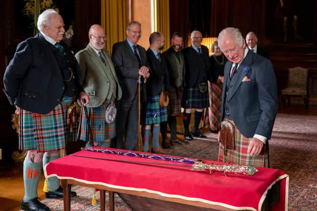 King Charles III (right) is shown the the Elizabeth Sword, part of the Honours of Scotland, by its designer Mark Dennis (left) at the Palace of Holyroodhouse in Edinburgh in the build-up to the coronation service. Picture: Jane Barlow/AFP via Getty Images