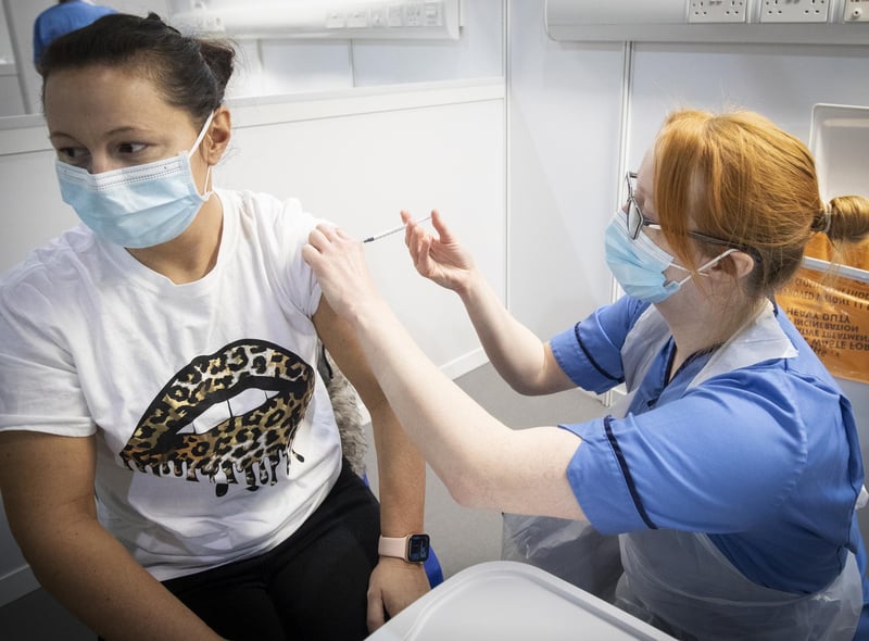Nurse Eleanor Pinkerton administers a coronavirus vaccine to one of the health and social care staff at the NHS Louisa Jordan Hospital in Glasgow in January.