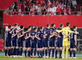 The Scotland squad stand for the national anthem prior to the clash in Vienna. Picture: SNS
