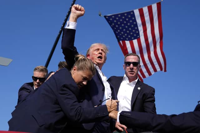 Wounded Republican presidential candidate and former President Donald Trump is surrounded by US Secret Service agents after an attempt on his life at a campaign rally in Butler, Pennsylvania, on Saturday (Picture: Evan Vucci/AP)