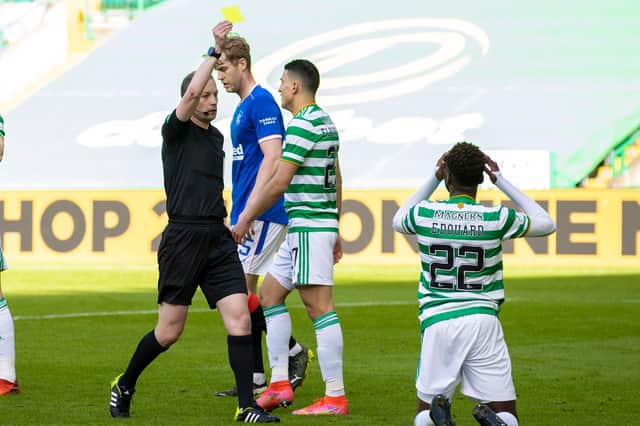 Celtic's Odsonne Edouard is booked for simulation by referee Willie Collum following a challenge from Borna Barisic. (Photo by Alan Harvey / SNS Group)