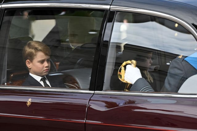 Prince George of Wales and Princess Charlotte of Wales are driven in car along the Mall after the State Funeral of Queen Elizabeth II.