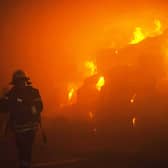 A rescuer putting out a fire in a building as a result of falling debris after a massive drone attack mainly targeting the Ukrainian capital Kyiv. Picture: Pavlo Petrov/State Emergency Service of Ukrai/AFP via Getty Images