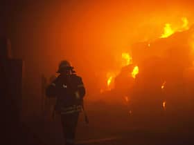 A rescuer putting out a fire in a building as a result of falling debris after a massive drone attack mainly targeting the Ukrainian capital Kyiv. Picture: Pavlo Petrov/State Emergency Service of Ukrai/AFP via Getty Images