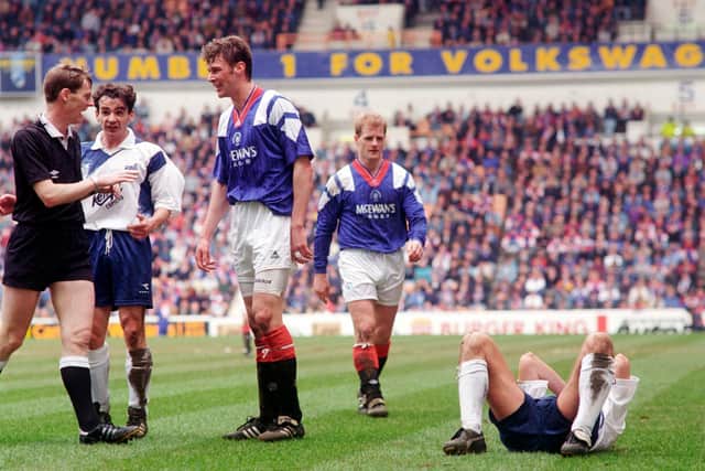 Referee Kenny Clark confronts Rangers striker Duncan Ferguson following a headbutt on Raith Rovers' Jock McStay. The notorious incident took place 27 years ago this week