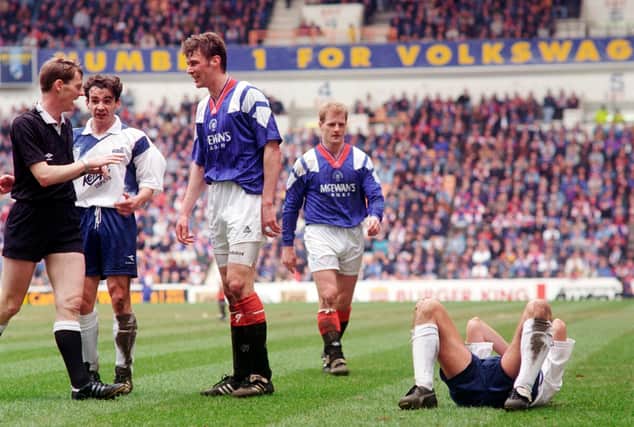 Referee Kenny Clark confronts Rangers striker Duncan Ferguson following a headbutt on Raith Rovers' Jock McStay. The notorious incident took place 27 years ago this week