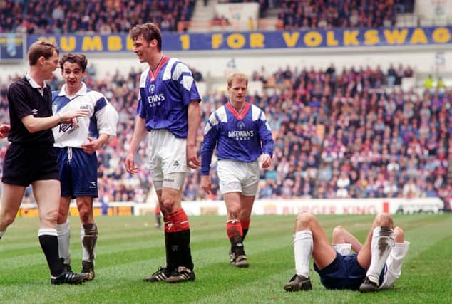 Referee Kenny Clark confronts Rangers striker Duncan Ferguson following a headbutt on Raith Rovers' Jock McStay.  The notorious incident took place 27 years ago this week