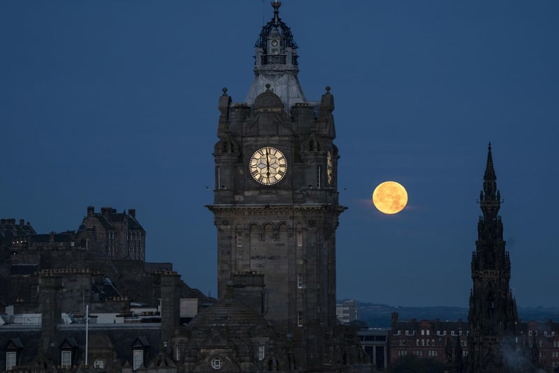 The super blue moon sets between the Balmoral Clock and the Scott Monument in Edinburgh.Photo: Jane Barlow/PA Wire