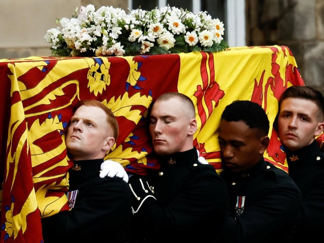 Pallbearers carrying the coffin of Queen Elizabeth II, draped with the Royal Standard of Scotland, as it arrives at Holyroodhouse, Edinburgh where it will lie in rest for a day. Picture date: Sunday September 11, 2022.
