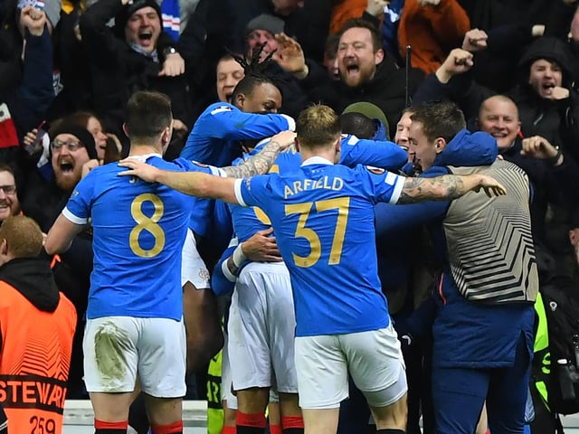 The team join the fans in raucous celebration (Photo by ANDY BUCHANAN / AFP) (Photo by ANDY BUCHANAN/AFP via Getty Images)