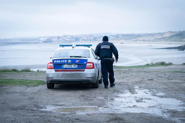 French police look out over a beach near Wimereux in France believed to have been from where those travelling aboard the boat that capsized set off from. Picture: Stefan Rousseau/PA Wire