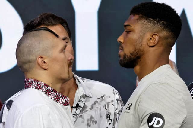 Ukraine's Oleksandr Usyk and Britain's Anthony Joshua face each other during a public weighing ahead of the heavyweight boxing rematch for the WBA, WBO, IBO and IBF titles between them, in the Saudi Red Sea city of Jeddah.