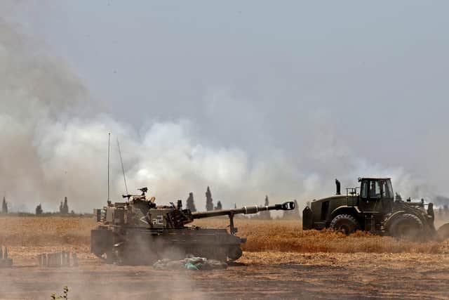 Israeli soldiers fire artillery shells towards the Gaza Strip from their position near the southern Israeli city of Sderot on May 14, 2021. (Photo by JACK GUEZ / AFP) (Photo by JACK GUEZ/AFP via Getty Images)