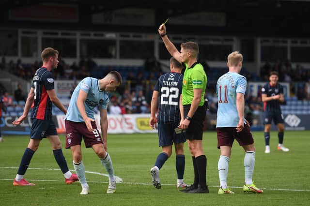 Hearts forward Ben Woodburn is booked at Ross County.