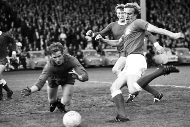 Aberdeen goalkeeper McGarr (left) dives on a loose ball as Rangers' Colin Stein closes in.
