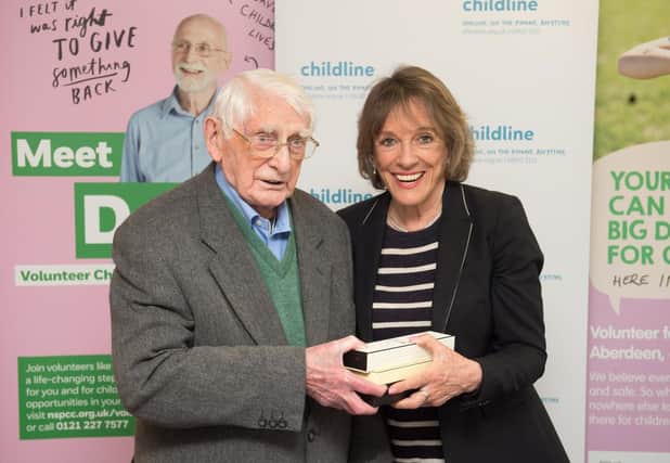 Norman Hutchison receiving an award from Esther Rantzen for his work with Childline (Picture: Childline)