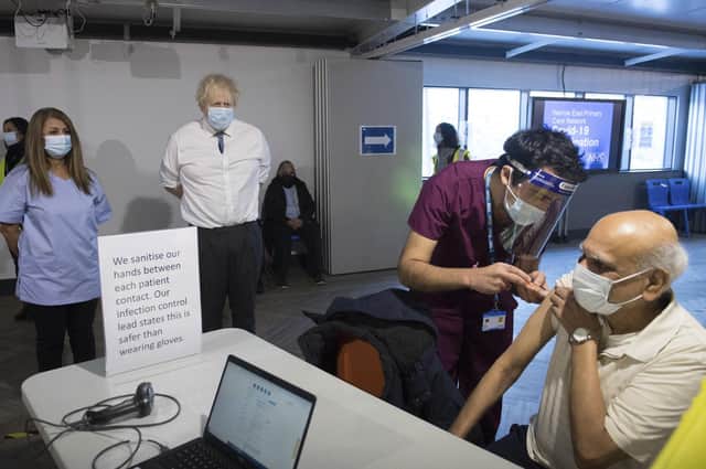 Boris Johnson watches a patient receiving a dose of the Oxford/AstraZeneca Covid vaccine, which was developed quickly partly because the virus is relatively simple and similar ones had been seen before (Picture: Stefan Rousseau/pool photograph via AP)