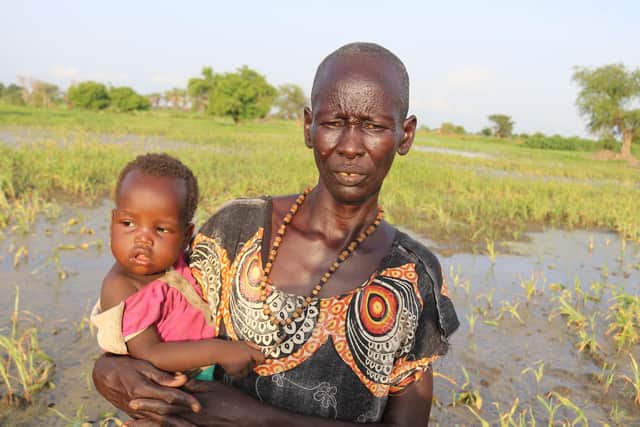 Asunta Nyanut Deng holding her grandchild