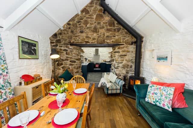 Delightful cottage Bwthyn Gerrig's dining room and well-equipped kitchen in the background