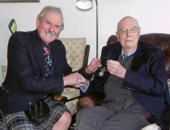 RAF captain John Cruickshank VC (right) who, at the age of 103, has been presented with the Air Efficiency Award, after a 75-year wait. Photo: Group Captain Bob Kemp/PA Wire