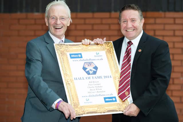 Davie Wilson (left) and alongside Hearts legend John Robertson after being inducted into the Scottish Football Hall of Fame in 2014. Picture: SNS