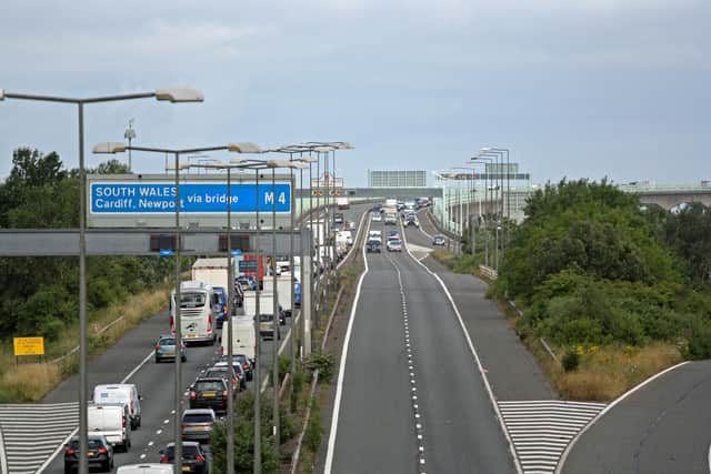 Police escort vehicles across the Prince of Wales Bridge, which runs between England and Wales, as drivers hold a go-slow protest on the M4