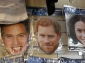 Masks showing Britain's Prince William, Prince Harrry, and his wife Meghan, right, are seen for sale in a shop in London, Friday, Jan. 6,