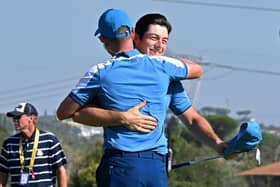 Europe's Norwegian golfer, Viktor Hovland (R) embraces Europe's English captain, Luke Donald on the 15th green after winning his foursomes match on the first day of play in the 44th Ryder Cup at the Marco Simone Golf and Country Club in Rome on September 29, 2023. (Photo by Andreas SOLARO / AFP) (Photo by ANDREAS SOLARO/AFP via Getty Images)