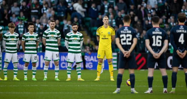 Celtic and Ross County players observe the Remembrance minute's silence that pockets of the home support demonstrated ignorance in disrupting. (Photo by Craig Foy / SNS Group)