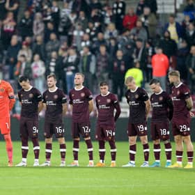 Hearts players stand wearing black armbands before the second half following the announcement of the death of Queen Elizabeth II, during the UEFA Europa Conference League Group A match at Tynecastle Park, Edinburgh.