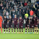 Hearts players stand wearing black armbands before the second half following the announcement of the death of Queen Elizabeth II, during the UEFA Europa Conference League Group A match at Tynecastle Park, Edinburgh.