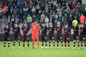 Hearts players stand wearing black armbands before the second half following the announcement of the death of Queen Elizabeth II, during the UEFA Europa Conference League Group A match at Tynecastle Park, Edinburgh.