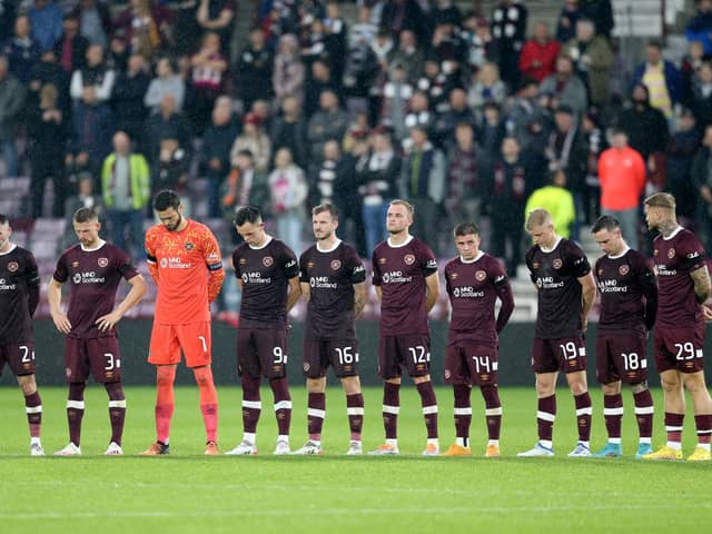 Hearts players stand wearing black armbands before the second half following the announcement of the death of Queen Elizabeth II, during the UEFA Europa Conference League Group A match at Tynecastle Park, Edinburgh.