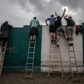 Football fans have been using ladders to get a glimpse of their team. Picture: Gabriel Kuchta/Getty Images