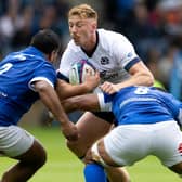 Scotland's Ben Healy is tackled by Italy's Toa Halafihi and Epalahame Faiva during the Summer Nations Series match at Scottish Gas Murrayfield.  (Photo by Ross Parker / SNS Group)