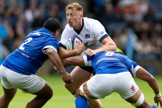 Scotland's Ben Healy is tackled by Italy's Toa Halafihi and Epalahame Faiva during the Summer Nations Series match at Scottish Gas Murrayfield. (Photo by Ross Parker / SNS Group)