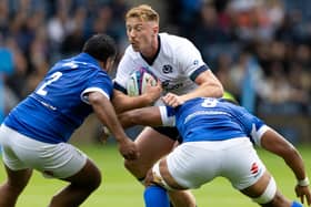 Scotland's Ben Healy is tackled by Italy's Toa Halafihi and Epalahame Faiva during the Summer Nations Series match at Scottish Gas Murrayfield.  (Photo by Ross Parker / SNS Group)