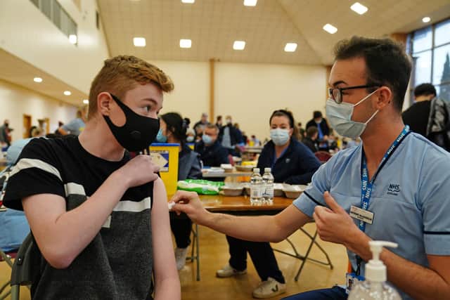 Owen Morrison, 15, receives his Covid-19 vaccine from student nurse Anthony McLaughlin during a vaccination clinic at the Glasgow Central Mosque.  Picture date: Monday January 3, 2022.
