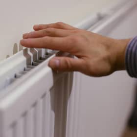 A hand on a radiator.