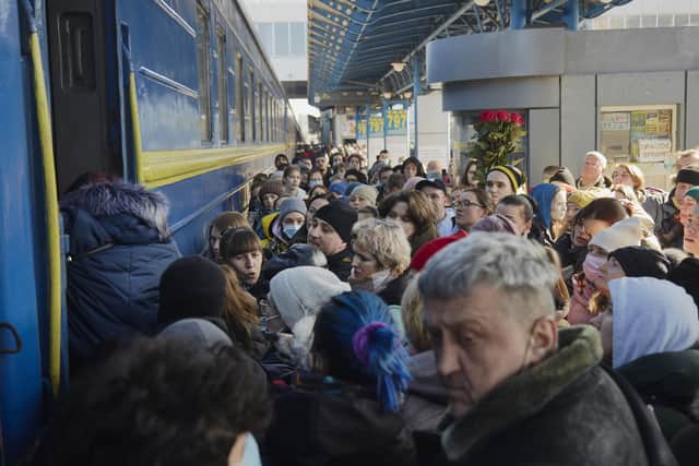 Kyiv residents scramble to get on a train out of the city on Saturday as Ukrainian officials report 198 citizens have been killed since the start of the Russian invasion.(Photo by Pierre Crom/Getty Images)