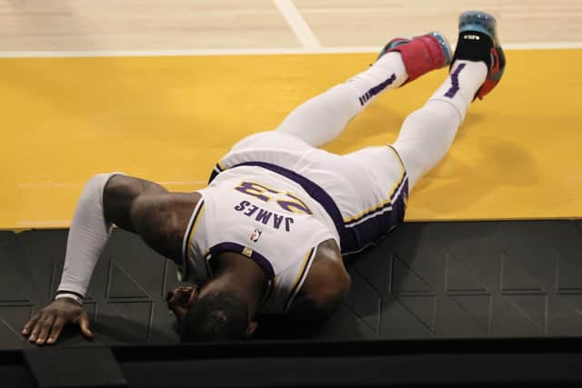 A sad sight for Los Angeles Lakers fans as LeBron James lies injured on the ground. He will miss the remainder of the season. Picture: Michael Owens/Getty Images