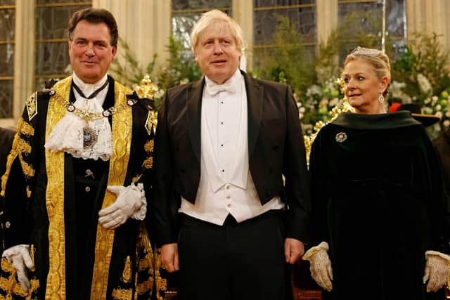 Britain's Prime Minister Boris Johnson (centre) poses with the new Lord Mayor of the City of London, Vincent Keaveny (left) at the Lord Mayor's Banquet in central London. Picture: Tolga Akmen/AFP via Getty Images