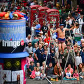 Edinburgh Festival Fringe entertainers perform on the Royal Mile on August 5, 2019. Photo by Jeff J Mitchell/Getty Images